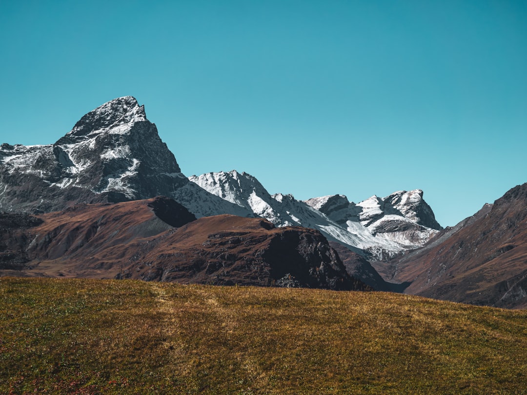 Snow-capped mountains under a clear blue sky